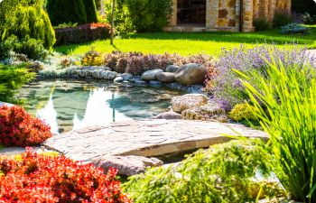 A landscaped garden with hardscapes and water features.