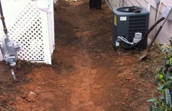 preparing ground for dry creek bed installation