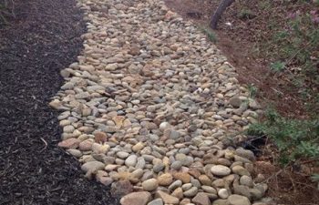 dry creek bed installed by Pannone’s Lawn Pros & Landscaping