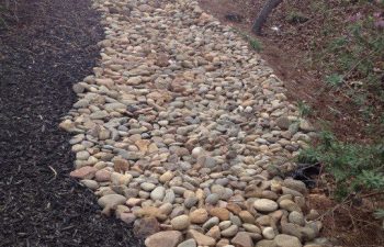 dry creek bed installed by Pannone’s Lawn Pros & Landscaping