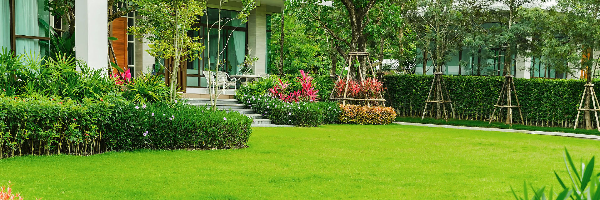 Professionally landscaped backyard with a manicured lawn.