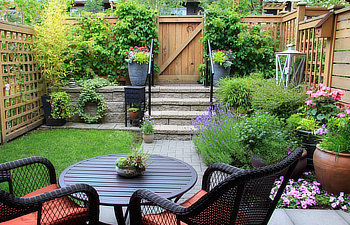 small townhouse garden with patio furniture amidst blooming lavender